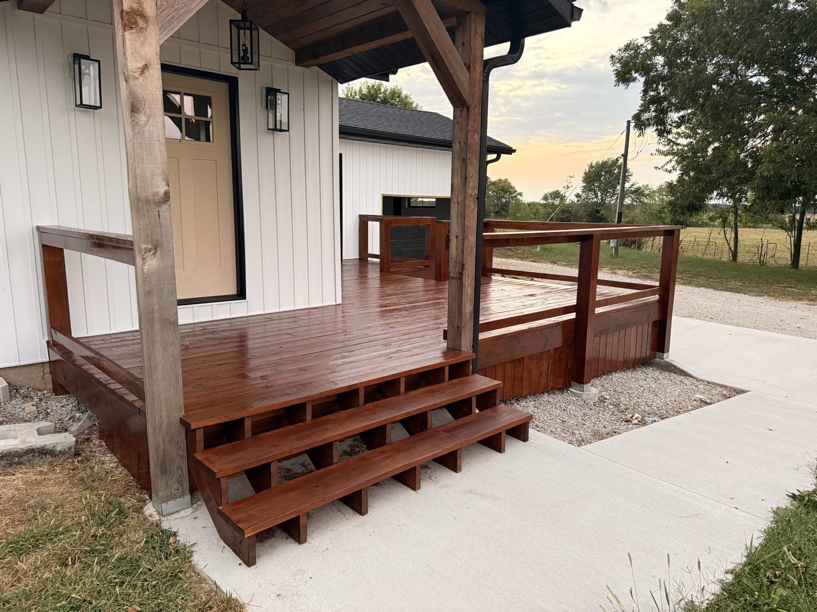 Covered porch and deck steps with a rich brown deck stain in Mountain Grove, MO