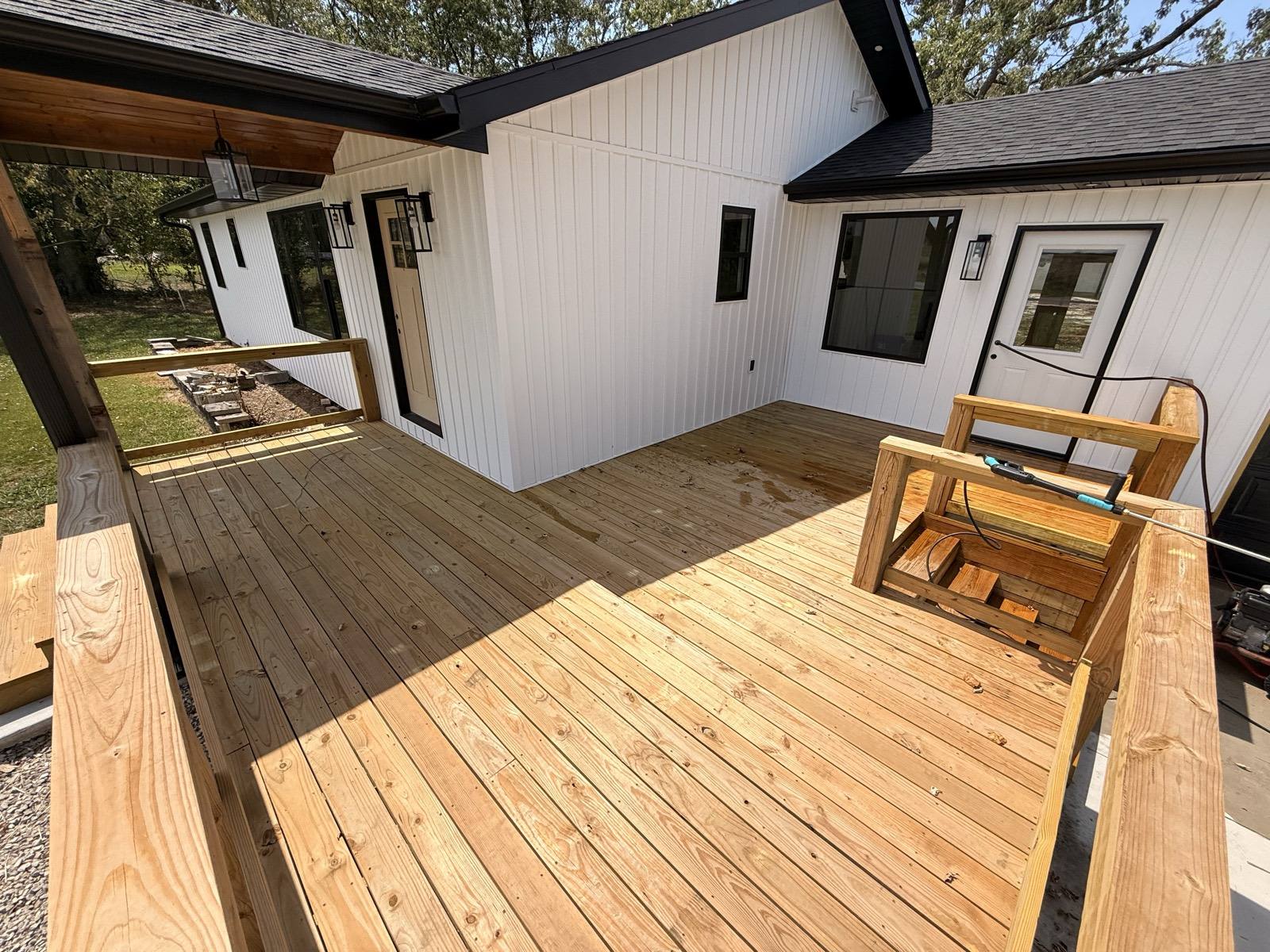 Home with brand-new unstained wood deck before staining in Mountain Grove, MO